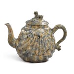 A STAFFORDSHIRE SOLID-AGATE PECTEN-SHELL TEAPOT AND COVER, CIRCA 1750