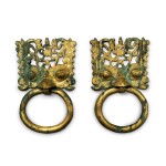 A rare pair of gilt-bronze mask and ring handles, Northern Wei dynasty | 北魏 銅鎏金透空鋪首活環一對