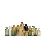 A collection of glass medicine bottles, various dates, mostly 17th and 18th centuries