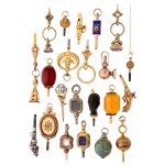 A group of 22 mixed media keys and fobs with mounts including metal, enamel and hardstone Various origins and dates