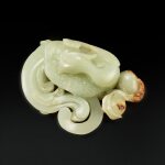 A white and russet jade 'phoenix and peach' group, Qing dynasty, 18th century | 清十八世紀 白玉瑞鳳蟠桃