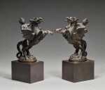 Pair of finials in the form of putti astride rearing griffins