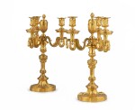 A pair of Louis XVI style gilt bronze four-light candelabra | Paire de candélabres à quatre lumières en bronze doré, de style Louis XVI,
