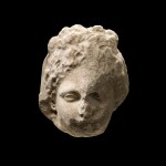 A Fragmentary Greek Marble Relief Head of a Woman, Attic, late 4th Century B.C.