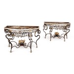  A PAIR OF SPANISH BAROQUE STYLE PIETRE DURE AND PARCEL-GILT WROUGHT IRON CONSOLE TABLES, THE TOPS AFTER THE BUEN RETIRO WORKSHOP