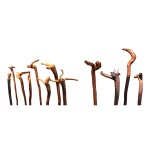 TWELVE EXCEPTIONAL FIGURATIVELY CARVED WOODEN WALKING STICKS, 20TH CENTURY