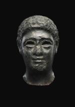 AN EGYPTIAN BASALT HEAD OF A MAN, LATE PTOLEMAIC PERIOD, CIRCA 100-30 B.C.