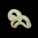 A white and russet jade openwork 'chilong' pendant, Ming dynasty | 明 白玉鏤雕螭龍珮